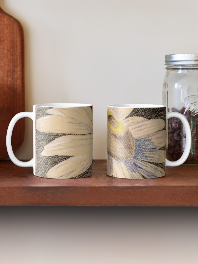two mugs on a shelf showing both sides of the print design Ox-eye Daisy