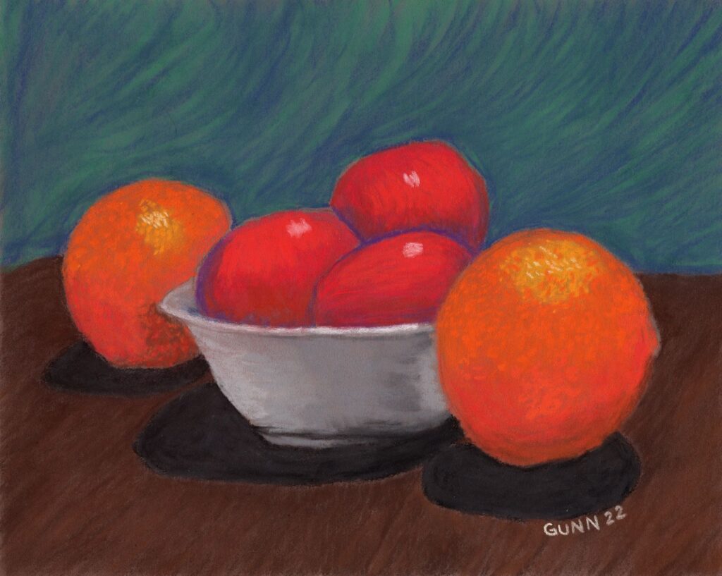 Apples and Oranges 2, second in a series of still life paintings featuring fruit in a bowl, soft pastel on Pastelmat, 24 by 30 cm 